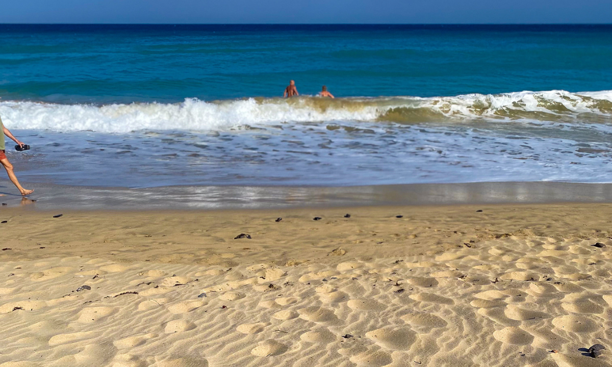 Two people playing in the sea at Playa de Esquinzo
