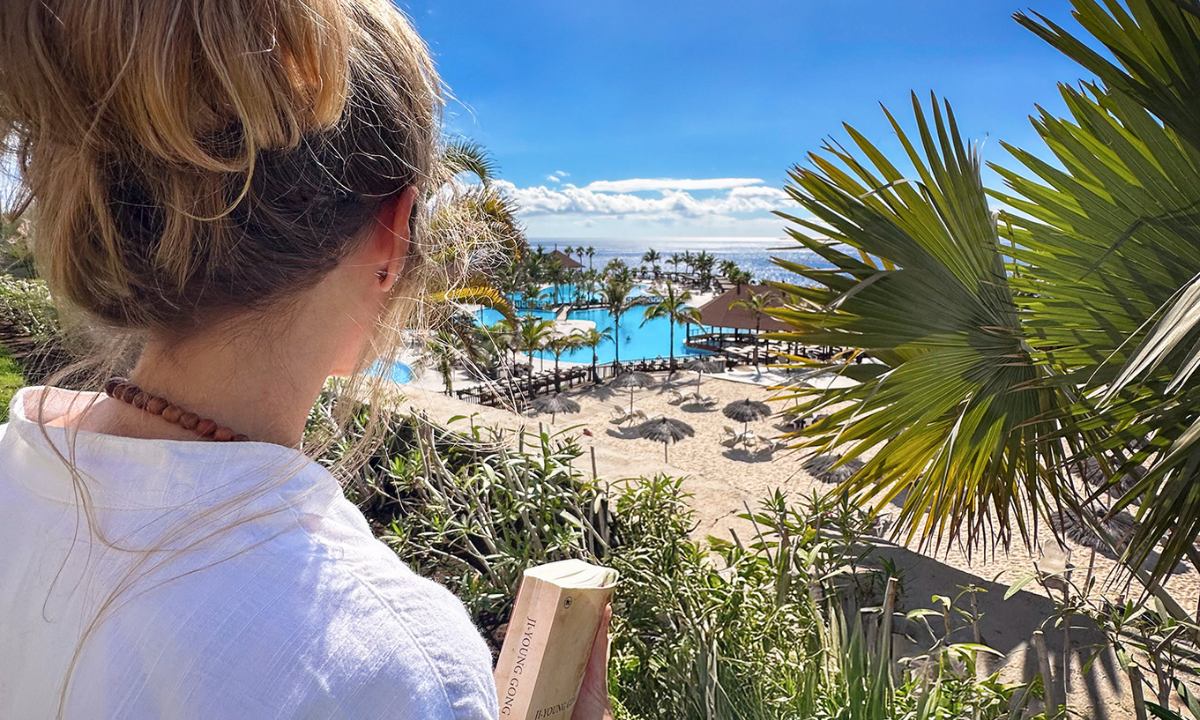 Woman overlooking the pool at La Palma Princess with the sea behind