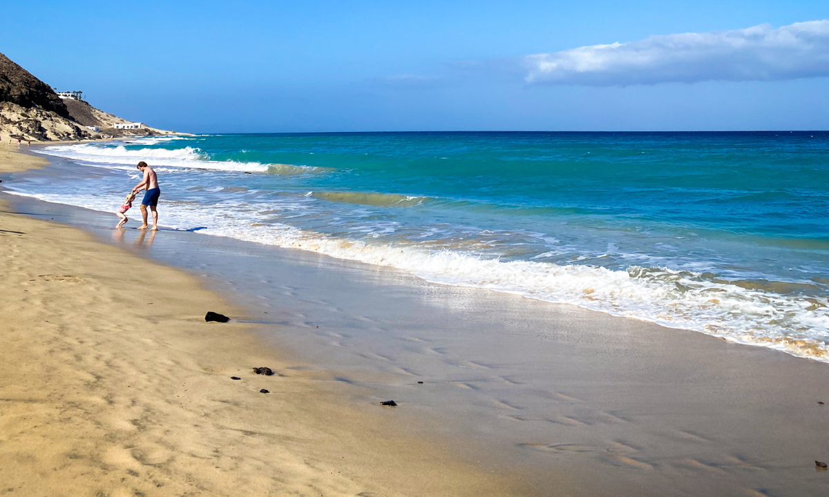 A father and daughter playing on Playa de Esquinzo